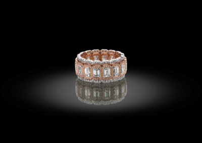 Special combination of emerald cut with brilliant cut diamonds, set in a melt between pink and white gold.